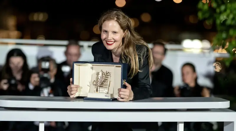La Directora Justine Triet Sonriendo Mientras Sostiene El Trofeo De La Palma De Oro Del Festival De Cannes 2023 En Su Estuche.