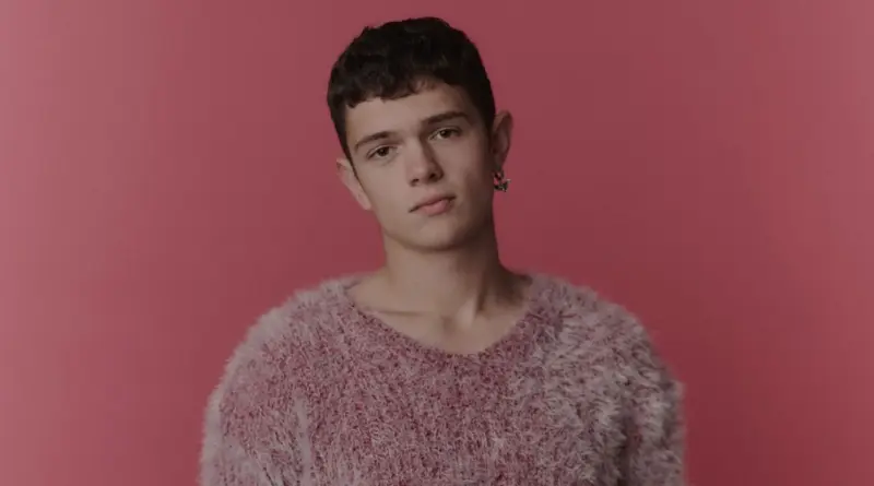 Retrato del actor Noah Jupe sobre un fondo rosa.