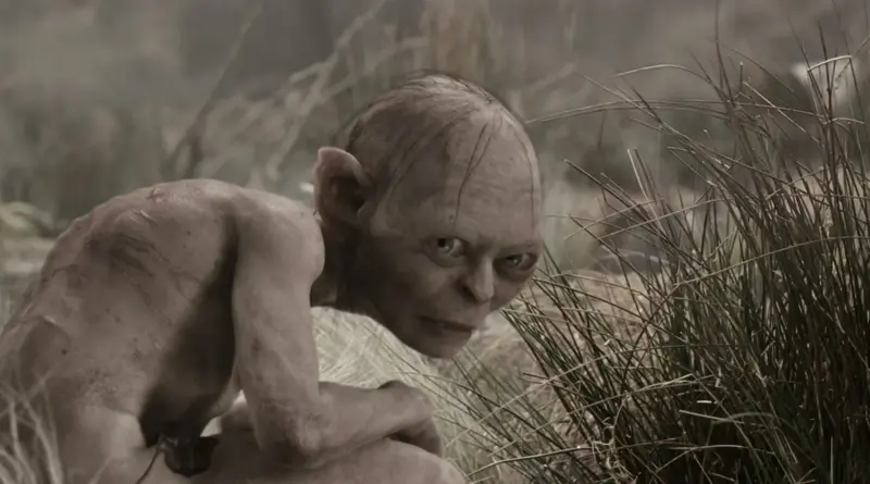 La criatura Gollum agazapada entre la hierba alta mirando fijamente hacia adelante. Será el foco de la película 'El Señor de los Anillos: La caza de Gollum'.