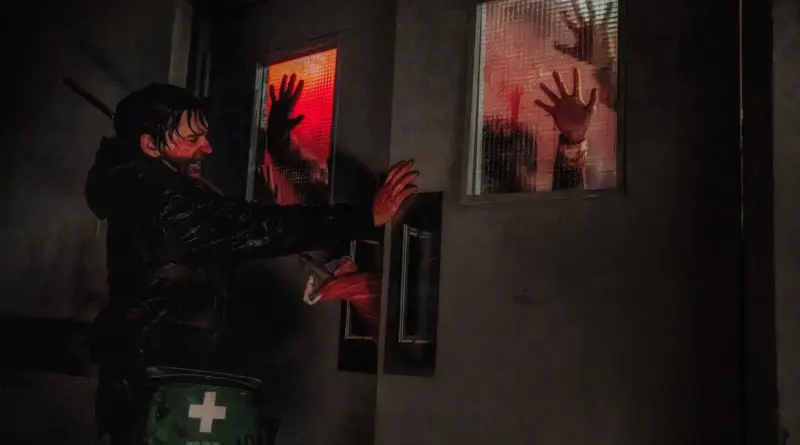Un hombre ensangrentado intenta mantener cerradas unas puertas dobles mientras manos golpean el cristal desde el otro lado en Resident Evil (2026)