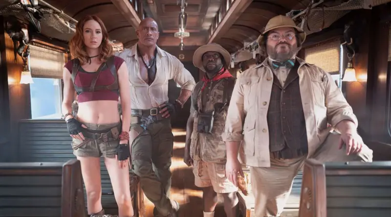 Los cuatro avatares icónicos posando listos para la acción dentro de un vagón de tren en Jumanji: mundo abierto.