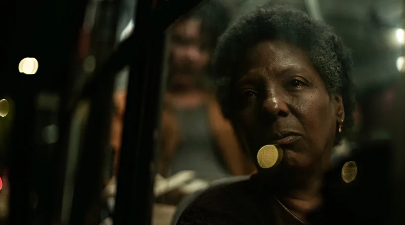 Primer plano de la protagonista de la película Las disculpas de Vicentina mirando reflexivamente por la ventanilla de un vehículo de noche.